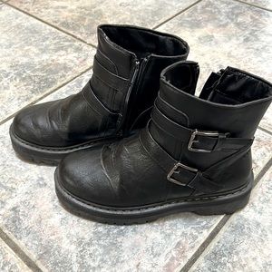 Combat boots with buckles and side zipper.